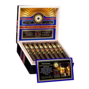 Perdomo Double-Aged 12-Year Vintage Maduro Churchill. Ornate wooden cigar box, containing numerous dark brown cigars, and featuring gold accents, a circular emblem, and a 12-year vintage label.