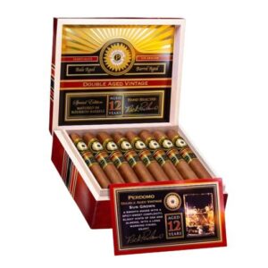 Ornate wooden cigar box containing several premium cigars, featuring a gold and red design and a detailed label.